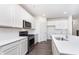 Modern kitchen featuring white cabinets, stainless steel appliances, and a large island at 5804 Summertree Pl, Whitestown, IN 46052
