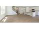 A spacious living area and modern kitchen feature white cabinets and hardwood floors, creating an inviting atmosphere at 5804 Summertree Pl, Whitestown, IN 46052