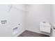 Functional laundry room with utility sink, washer hookups, and overhead shelving for storage at 5804 Summertree Pl, Whitestown, IN 46052