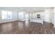 Bright living room with hardwood floors, large windows, and an open-concept kitchen with stainless steel appliances at 5804 Summertree Pl, Whitestown, IN 46052