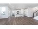 Open concept living room and kitchen area with modern finishes and hardwood flooring at 5804 Summertree Pl, Whitestown, IN 46052