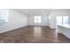 Spacious and light-filled living room with hardwood floors and large windows at 5804 Summertree Pl, Whitestown, IN 46052