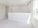 Upstairs loft space with a large window and plush carpeting for a cozy feel at 5804 Summertree Pl, Whitestown, IN 46052