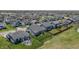 Aerial view of a neighborhood with well-maintained homes and a community pond, with manicured lawns and outdoor seating at 6472 W Treeline Ln, McCordsville, IN 46055