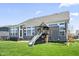 Backyard featuring a play structure, and the home's exterior with large windows at 6472 W Treeline Ln, McCordsville, IN 46055