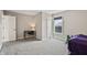 Inviting bedroom featuring soft carpeting, a window with natural light, and a doorway for easy access at 6472 W Treeline Ln, McCordsville, IN 46055