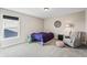 Cozy bedroom with soft carpeting, a comfortable chair, and a large window for plenty of natural light at 6472 W Treeline Ln, McCordsville, IN 46055