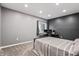 Well-lit bedroom featuring a bed and desk and a view to the exterior at 6472 W Treeline Ln, McCordsville, IN 46055