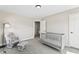Charming Bedroom with soft carpeting, a gray crib, and a comfortable chair perfect for relaxing with your baby at 6472 W Treeline Ln, McCordsville, IN 46055