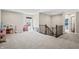 Spacious bonus room with neutral walls, plush carpet, and natural light perfect for Gathering activities and relaxation at 6472 W Treeline Ln, McCordsville, IN 46055
