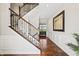 Grand foyer with hardwood floors, staircase with iron railings, and wainscoting, creating a welcoming entrance at 6472 W Treeline Ln, McCordsville, IN 46055