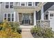 Inviting front entrance featuring stone accents, decorative wreath, and covered porch, offering a warm welcome at 6472 W Treeline Ln, McCordsville, IN 46055