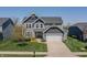 Beautiful two-story home features a well-manicured lawn, two-car garage, and charming curb appeal at 6472 W Treeline Ln, McCordsville, IN 46055