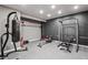 Home gym equipped with various workout machines, rubber floors, and ample space for a complete fitness routine at 6472 W Treeline Ln, McCordsville, IN 46055