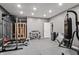 Spacious home gym with sauna, weight rack, heavy bag, and rubber flooring at 6472 W Treeline Ln, McCordsville, IN 46055