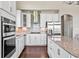 Kitchen featuring white cabinets, stainless steel appliances, and a stainless backsplash at 6472 W Treeline Ln, McCordsville, IN 46055