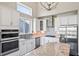 Kitchen featuring stainless steel appliances, white cabinets, and granite countertops at 6472 W Treeline Ln, McCordsville, IN 46055