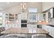 Open kitchen with granite counters, stainless appliances, and white cabinets at 6472 W Treeline Ln, McCordsville, IN 46055