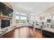 Open living room with a stone fireplace, large windows, and hardwood floors, perfect for relaxing and entertaining at 6472 W Treeline Ln, McCordsville, IN 46055