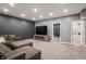 Carpeted living room features recessed lighting, a large TV, and a view of the bathroom at 6472 W Treeline Ln, McCordsville, IN 46055
