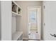 Bright mudroom with a built-in storage bench, coat hooks, and direct access to the laundry room at 6472 W Treeline Ln, McCordsville, IN 46055