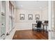 Bright home office with hardwood floors, wainscoting, and a large window, perfect for a productive workspace at 6472 W Treeline Ln, McCordsville, IN 46055