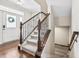 Elegant staircase featuring wooden railings, plush carpeting, and abundant natural light from the front entryway at 6472 W Treeline Ln, McCordsville, IN 46055