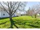 Spacious backyard featuring a well-maintained lawn and mature trees, perfect for outdoor activities and relaxation at 718 Marie Ln, Fortville, IN 46040
