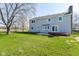 Expansive backyard with a concrete patio and a raised deck provides ample space for entertaining and leisure at 718 Marie Ln, Fortville, IN 46040