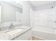 The bright bathroom features granite countertop, modern sink, with a tub and shower combination at 718 Marie Ln, Fortville, IN 46040