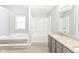 Bright bathroom featuring tub-shower combo, granite vanity with double sinks at 718 Marie Ln, Fortville, IN 46040