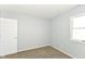 Minimalist bedroom featuring soft carpet, natural light, and modern color palette at 718 Marie Ln, Fortville, IN 46040