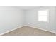 Bedroom with soft carpet, bright window, and painted in a soft neutral color at 718 Marie Ln, Fortville, IN 46040