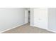 A relaxing bedroom features neutral walls and carpet with a closet for storage and a doorway at 718 Marie Ln, Fortville, IN 46040