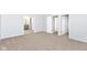 A neutral bedroom boasts a carpeted floor with a bathroom view and white painted doors at 718 Marie Ln, Fortville, IN 46040