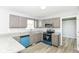 Modern kitchen with gray cabinets, stainless steel appliances, and granite countertops at 718 Marie Ln, Fortville, IN 46040
