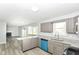 Open concept kitchen features gray cabinets, stainless appliances, and granite countertops at 718 Marie Ln, Fortville, IN 46040