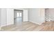 Open living area with wood floors, fresh gray paint, and entry to back yard with large white double doors at 718 Marie Ln, Fortville, IN 46040