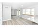 Bright and spacious living room features new wood flooring and lots of natural light at 718 Marie Ln, Fortville, IN 46040