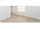 Bright living room features new wood floors, modern paint, and plenty of natural light from the large window at 718 Marie Ln, Fortville, IN 46040