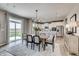 Dining room with patio access featuring contemporary lighting and neutral decor at 7337 Deerberg Dr, Indianapolis, IN 46259