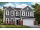 Charming two-story home with gray siding, brick accents, and a two-car garage at 7337 Deerberg Dr, Indianapolis, IN 46259