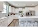 Bright kitchen with white cabinets, a center island with seating, and stainless steel appliances at 7337 Deerberg Dr, Indianapolis, IN 46259