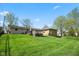 Expansive backyard featuring a well-maintained lawn and a charming deck, perfect for outdoor entertaining at 7482 N Maple Dr, Frankton, IN 46044
