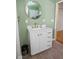 Charming bathroom features a stylish vanity with a round mirror, a tile floor, and a soft, pale green wall color at 7482 N Maple Dr, Frankton, IN 46044