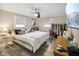 Bedroom with hardwood floors, a ceiling fan, and two windows that provide ample natural light at 7482 N Maple Dr, Frankton, IN 46044