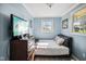 Bright bedroom with a cozy bed, natural light, a dresser, and light blue walls to create a serene space at 7482 N Maple Dr, Frankton, IN 46044
