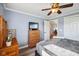 Well-lit bedroom featuring a dresser, ceiling fan, and a window, providing a bright and airy atmosphere at 7482 N Maple Dr, Frankton, IN 46044