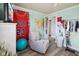 Cozy bedroom featuring a comfy chair, vibrant decor, and modern flooring at 7482 N Maple Dr, Frankton, IN 46044
