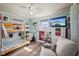 Bright bedroom with hardwood floors, a bunk bed with basketball hoop, and a ceiling fan at 7482 N Maple Dr, Frankton, IN 46044